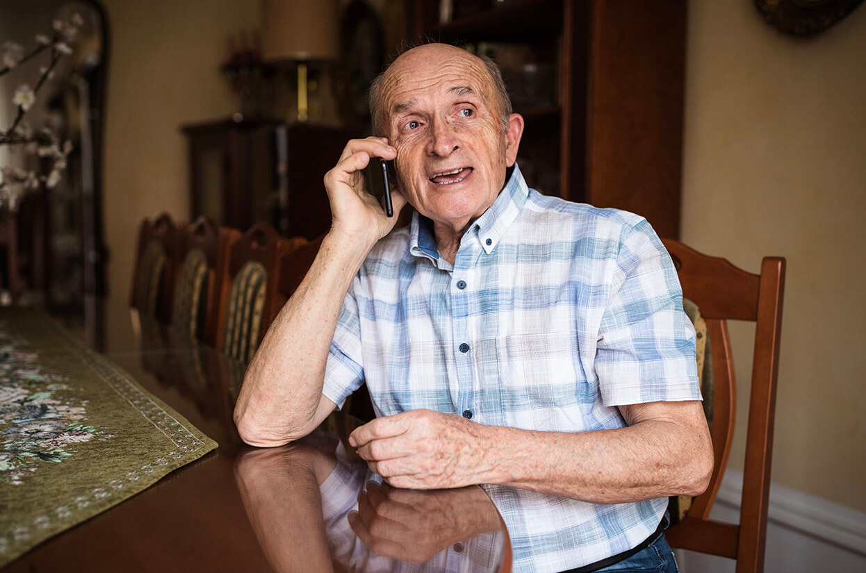 An older man on the phone