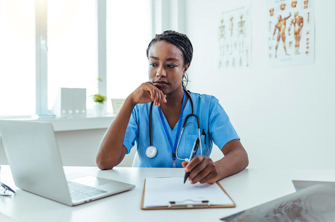 Medical Professiona Writing On A Pad