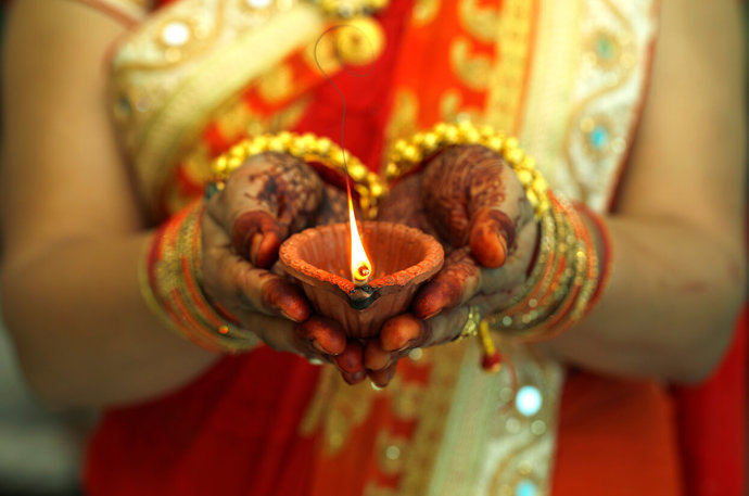 An woman holding a candle at diwali
