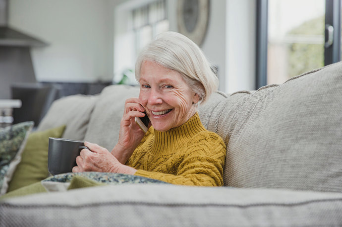 An older woman enjoying a conversation on the phone 