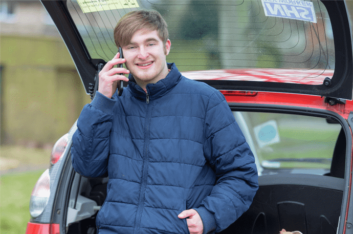 A younger volunteer on his phone 