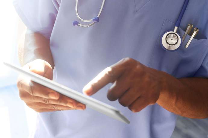 A doctor pointing at a personal tablet 