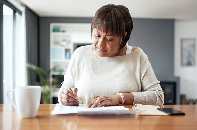 A woman looking at some correspondance 