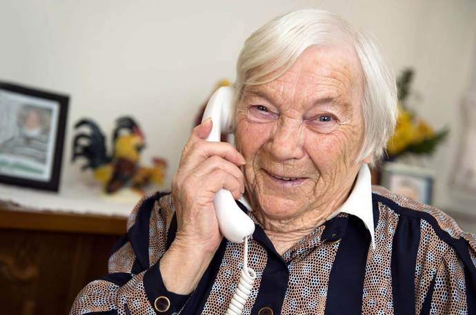 An older woman on her landline phone 