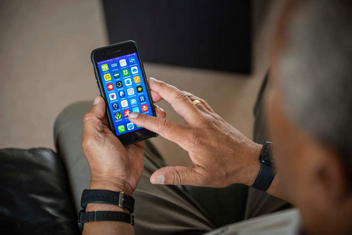 A Volunteer Responder checking his app on a mobile phone 