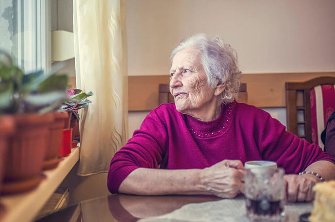 An older woman sitting in her home alone