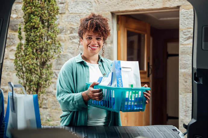 A female volunteer delivering prescriptions to someone's home 