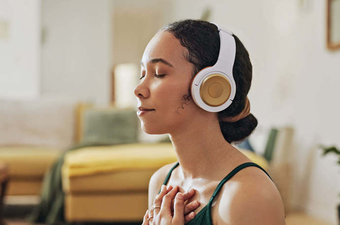 A younger woman wearing headphones 